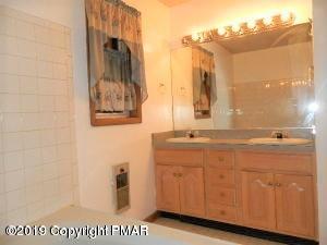 152 Chestnut Drive Bushkill, PA 18324 - Photo 25 of 34 a bathroom with a sink and a mirror