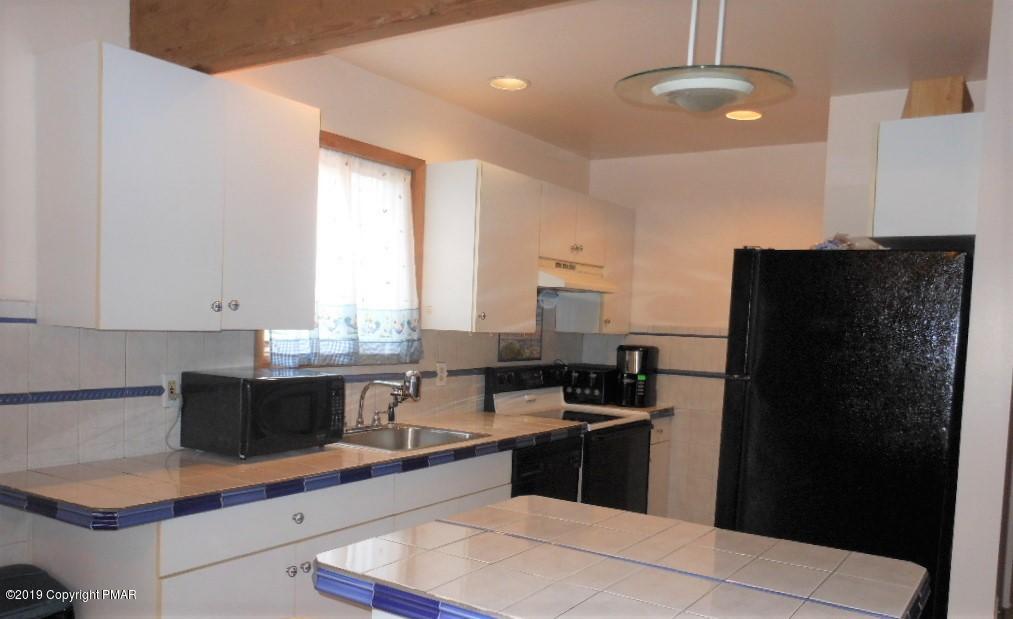 152 Chestnut Drive Bushkill, PA 18324 - Photo 7 of 34 a kitchen with a sink a refrigerator and cabinets