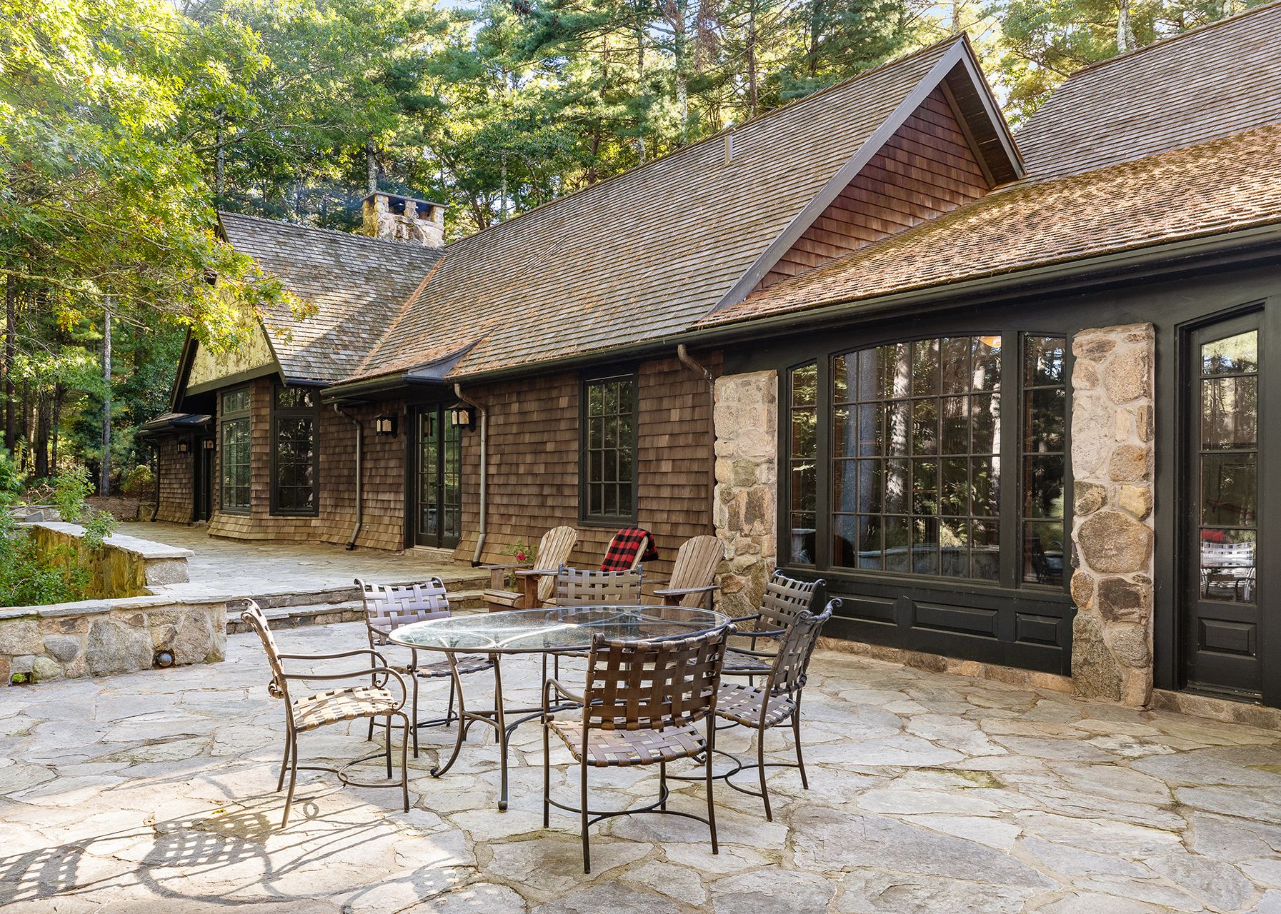 9 Two Holes Of Water Road East Hampton, NY 11937 - Photo 13 of 52 a view of a patio with a table and chairs
