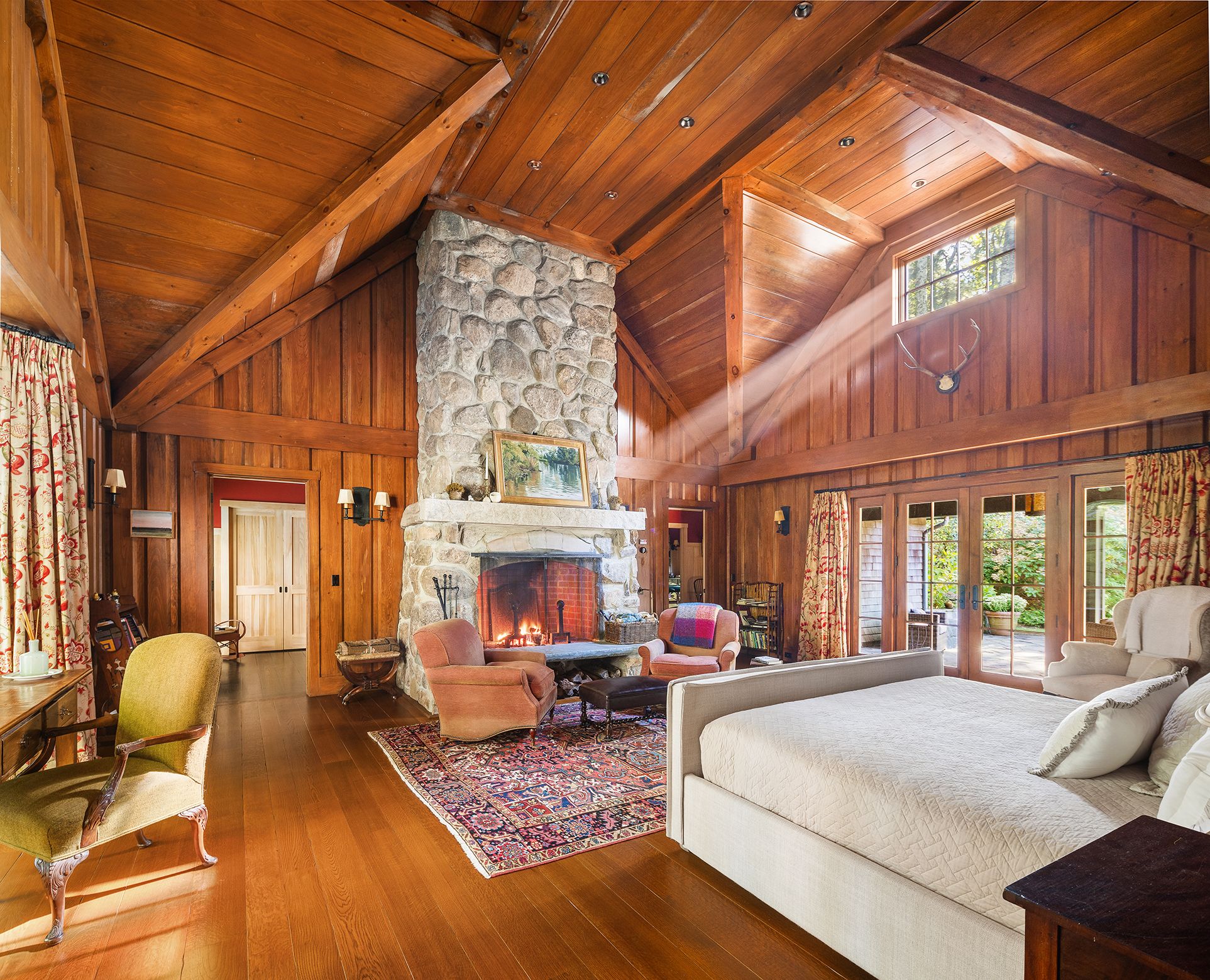 9 Two Holes Of Water Road East Hampton, NY 11937 - Photo 21 of 52 a living room with furniture a fireplace and large windows