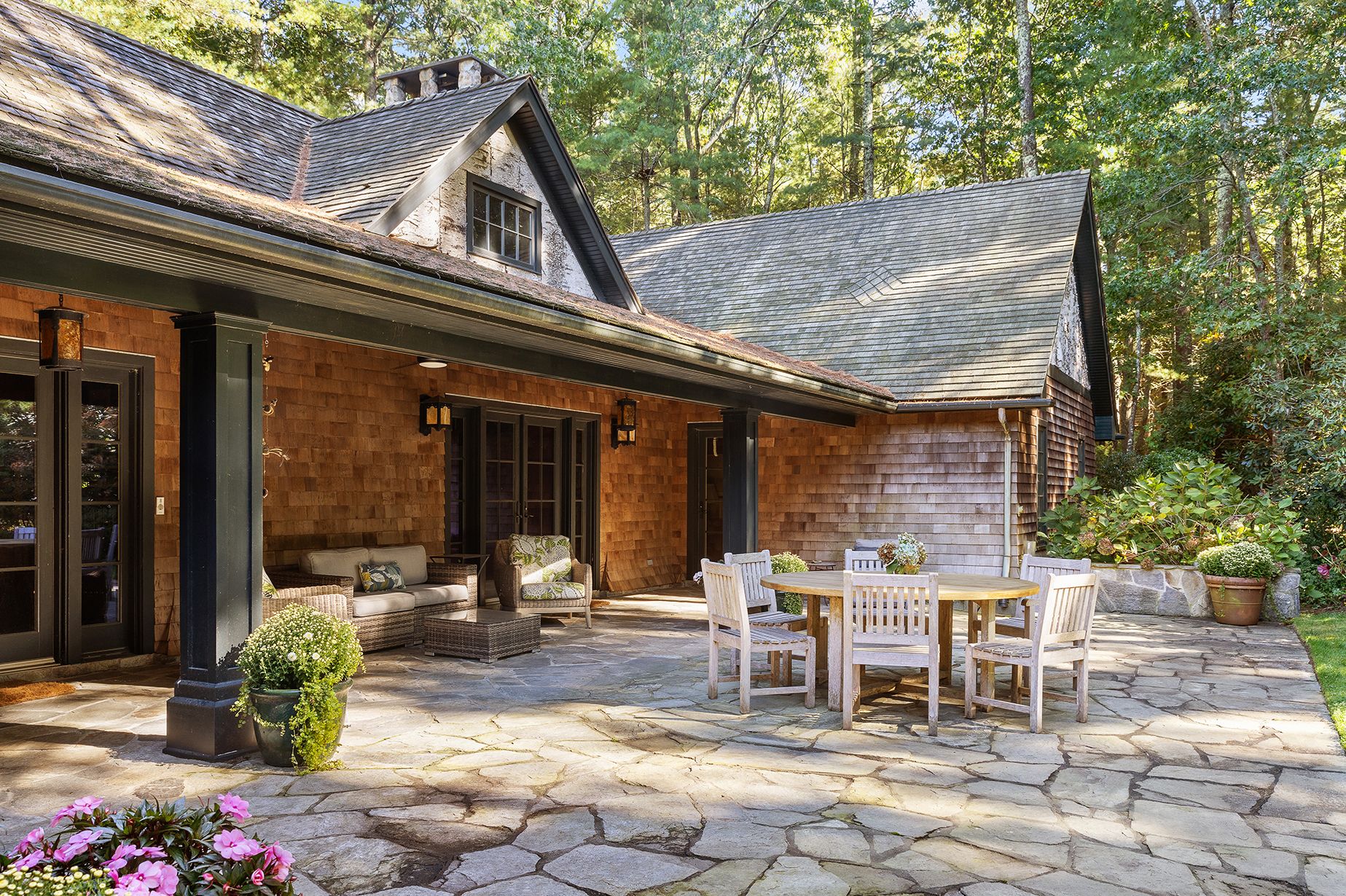 9 Two Holes Of Water Road East Hampton, NY 11937 - Photo 30 of 52 a view of a patio with table and chairs and potted plants
