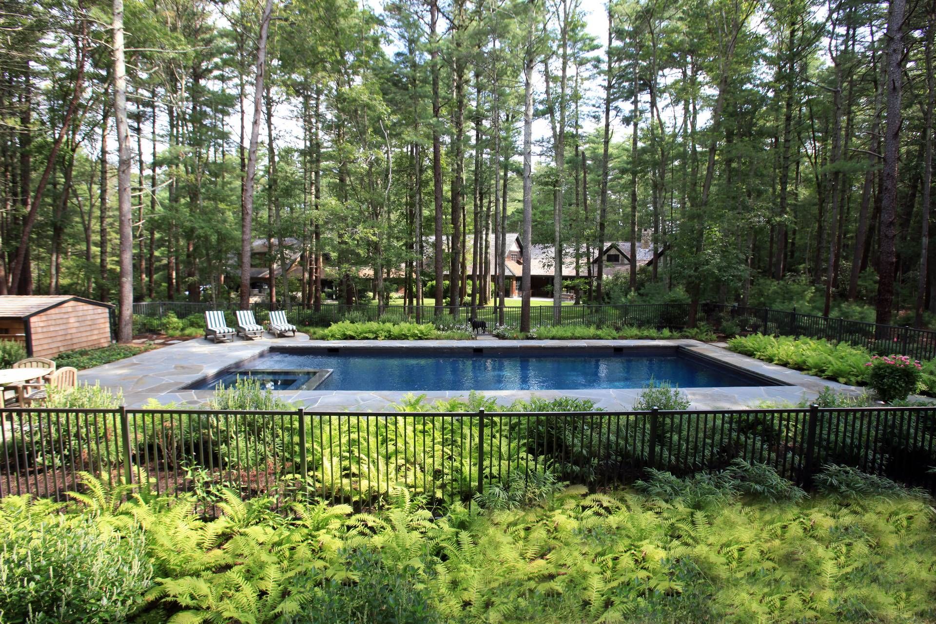 9 Two Holes Of Water Road East Hampton, NY 11937 - Photo 32 of 52 a view of swimming pool with lawn chairs and plants