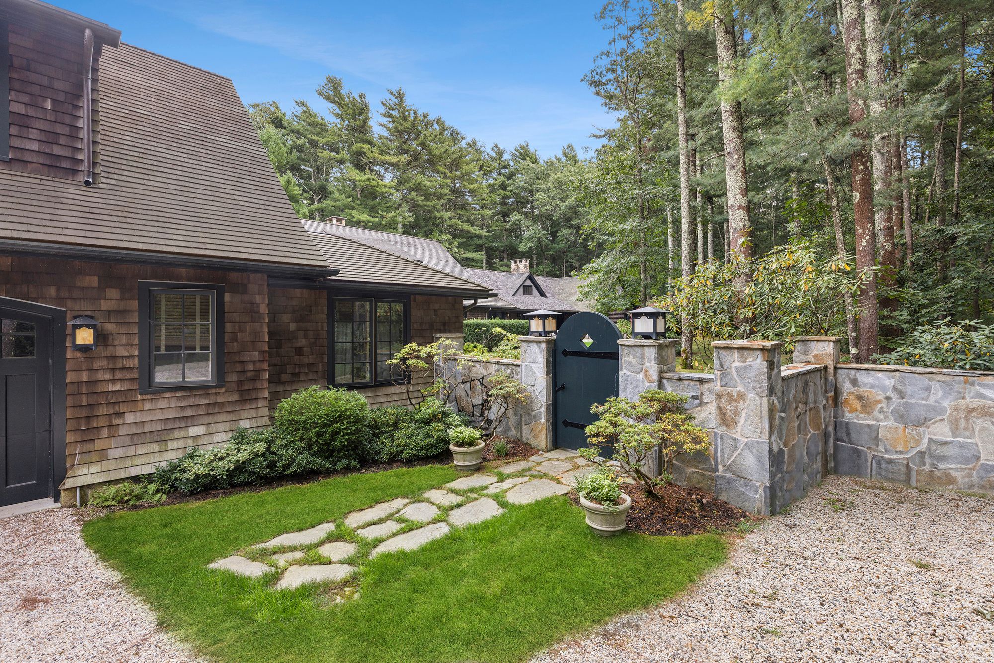 9 Two Holes Of Water Road East Hampton, NY 11937 - Photo 44 of 52 a view of a chair and table in backyard of the house