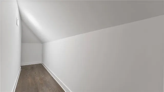 a view of hallway with window and wooden floor