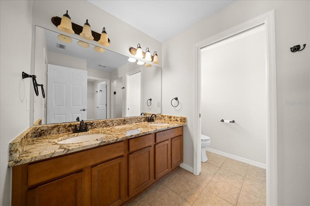234 Locust Lane Ocala, FL 34472 - Photo 55 of 71 a bathroom with a granite countertop sink and a mirror