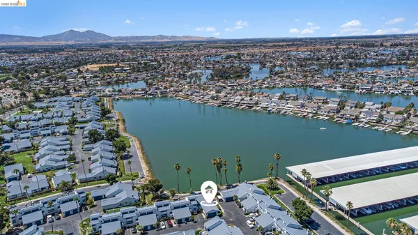 an aerial view of a house with a lake