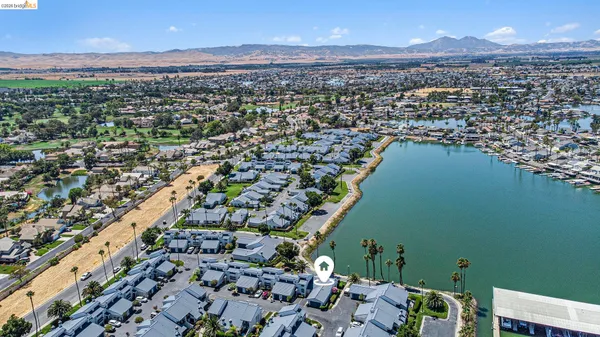 an aerial view of a houses with a lake
