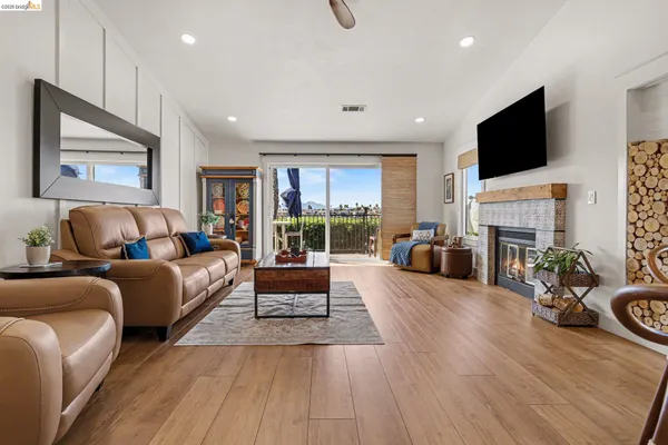 a living room with fireplace furniture and a flat screen tv