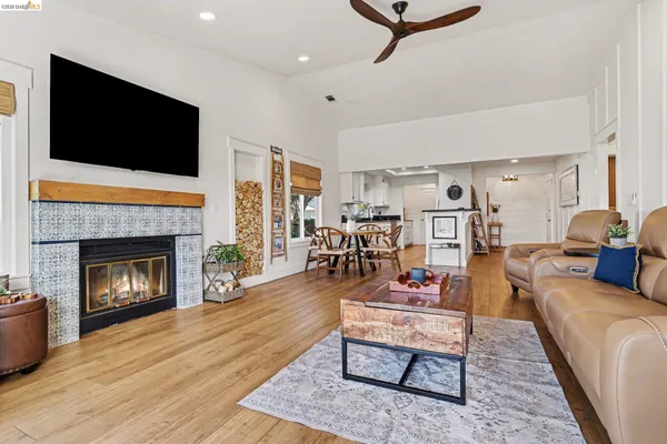 a living room with furniture a flat screen tv and a fireplace