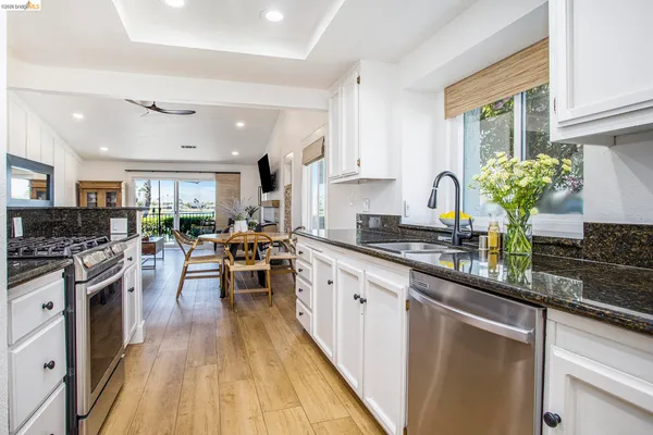 a kitchen with lots of counter top space and wooden floor