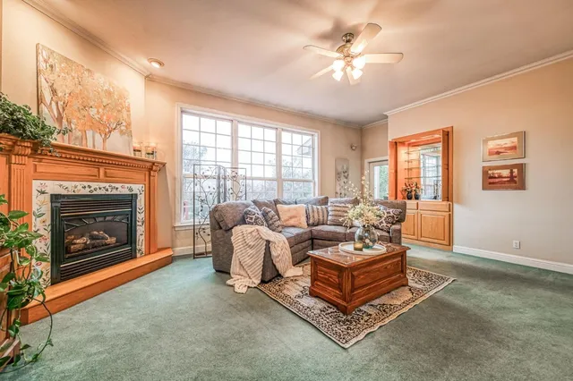 a living room with a large window and a table