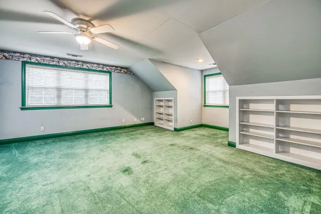 a spacious bedroom with a bed and a window