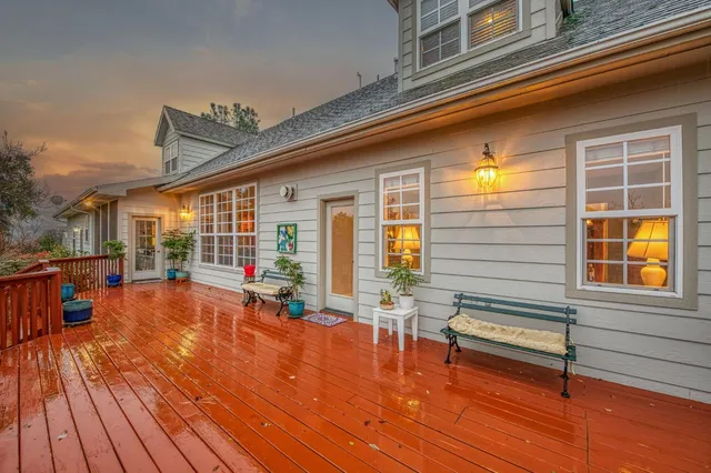 a living room with furniture a fireplace and a large window