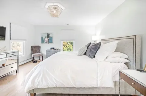 a bathroom with a sink vanity mirror and toilet
