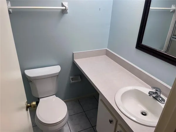 a white toilet sitting next to a bathroom sink