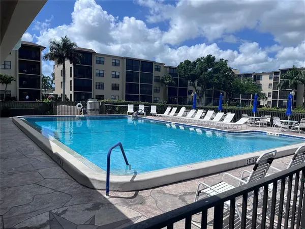 a view of swimming pool with outdoor seating
