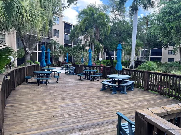 a view of a patio with couches table and chairs and potted plants