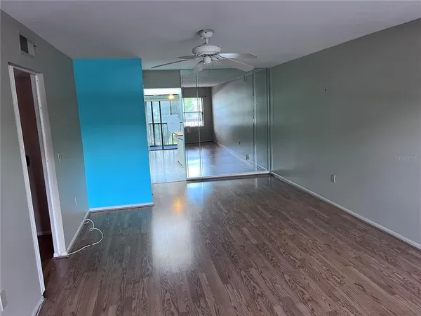 a view of a hallway with wooden floor