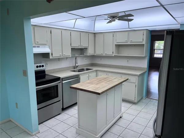 a kitchen with stainless steel appliances a sink and cabinets