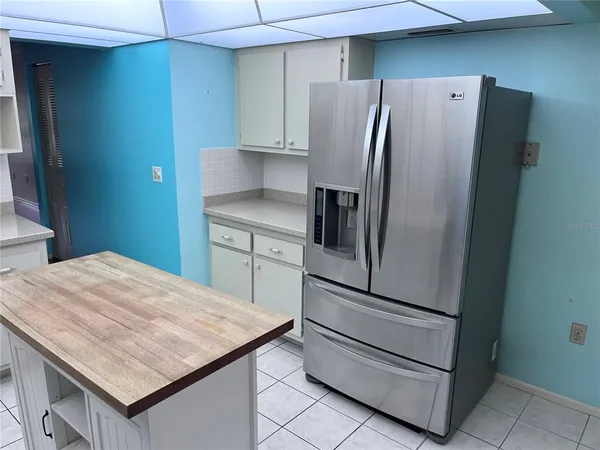 a kitchen with appliances and a refrigerator
