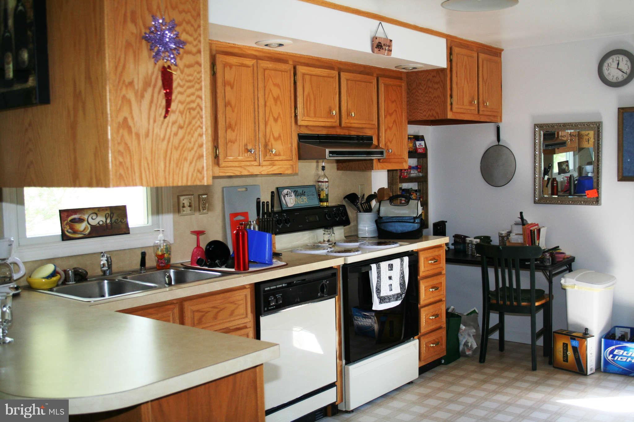 10807 Haughs Church Road Keymar, MD 21757 - Photo 2 of 17 a kitchen with stainless steel appliances granite countertop a sink dishwasher stove and cabinets