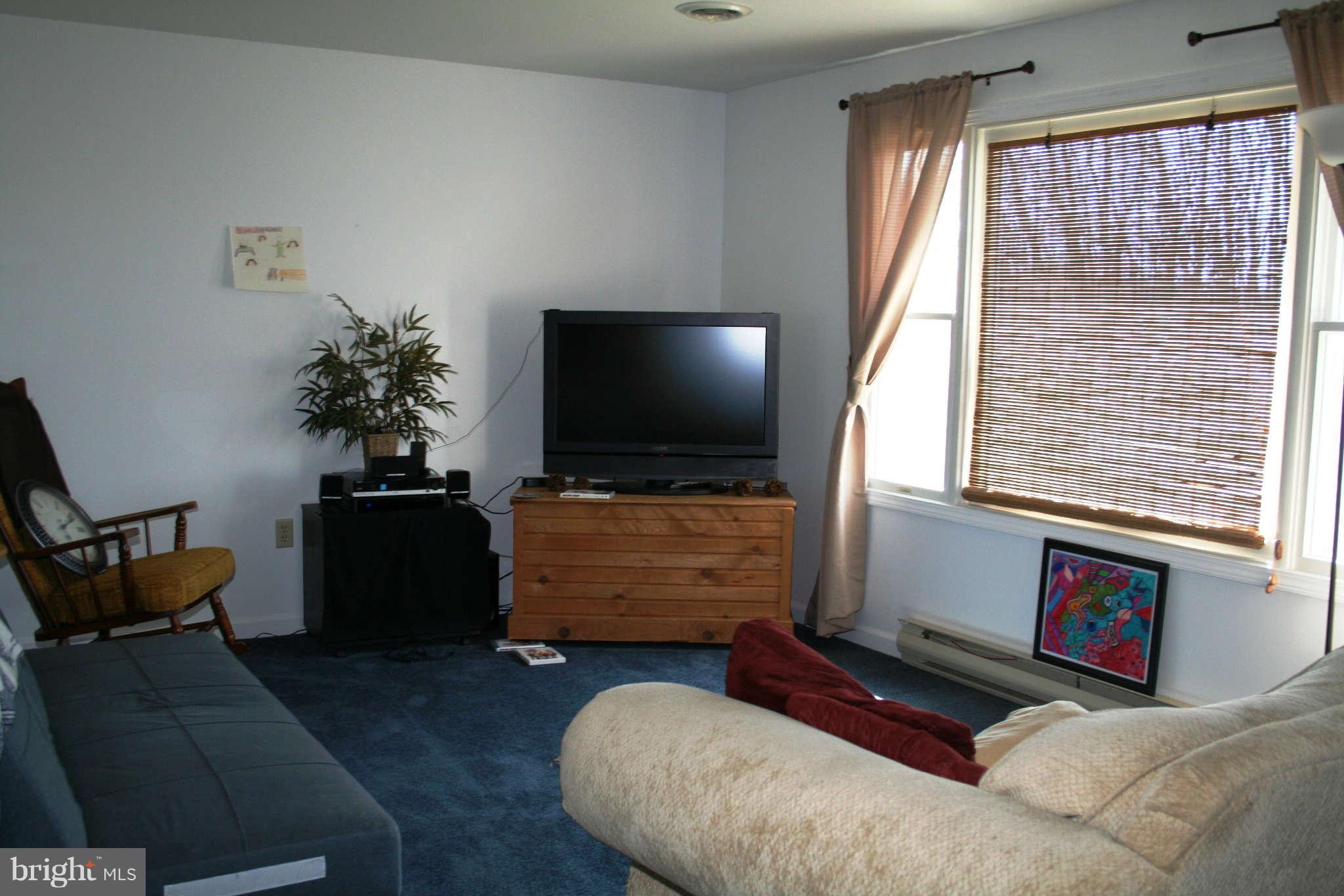10807 Haughs Church Road Keymar, MD 21757 - Photo 4 of 17 a living room with furniture and a flat screen tv