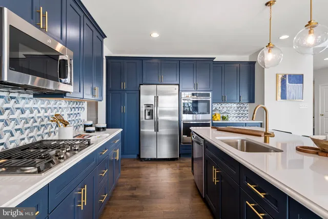 a kitchen with a sink stainless steel appliances and cabinets