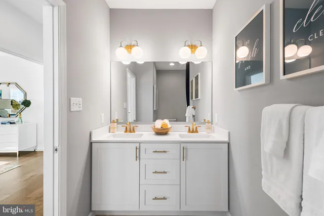 a bathroom with a double vanity sink and a mirror