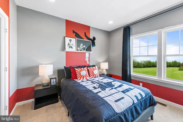 a bedroom with a bed lamp and window