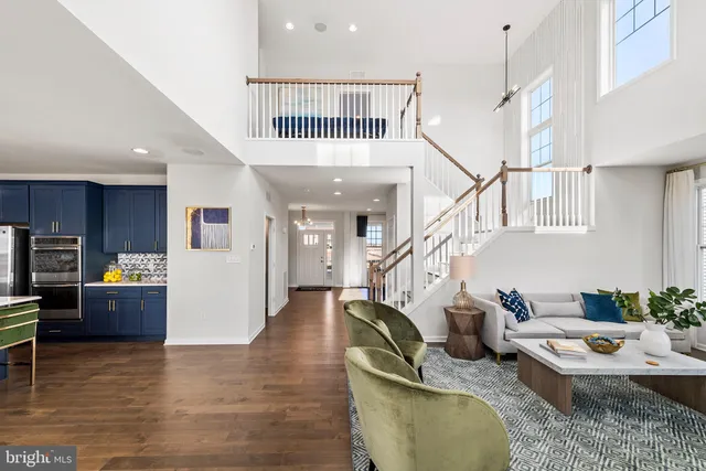 a living room with furniture and kitchen view