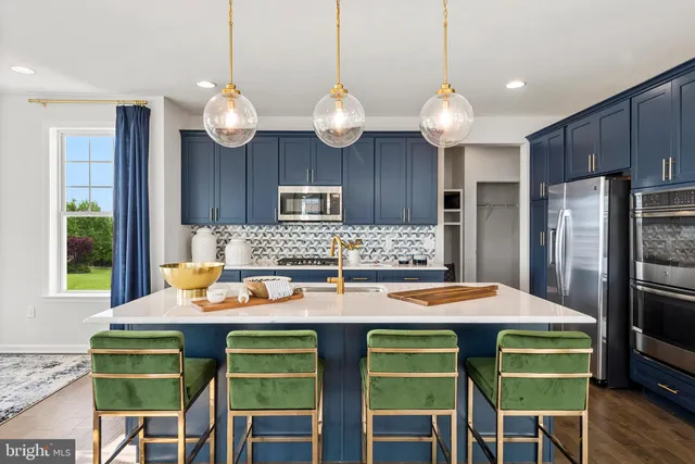 a kitchen with a dining table and chairs with kitchen area