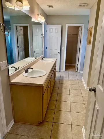 a bathroom with a sink a toilet a mirror and vanity