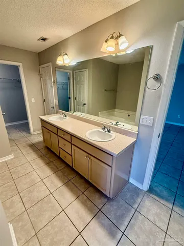 a bathroom with a sink vanity and a mirror