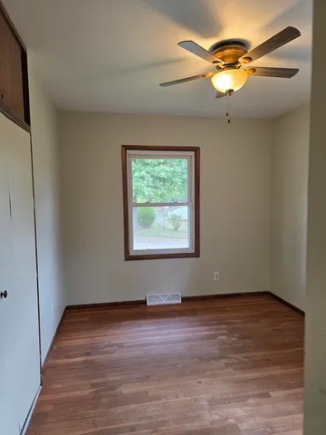 a view of room with window and wooden floor