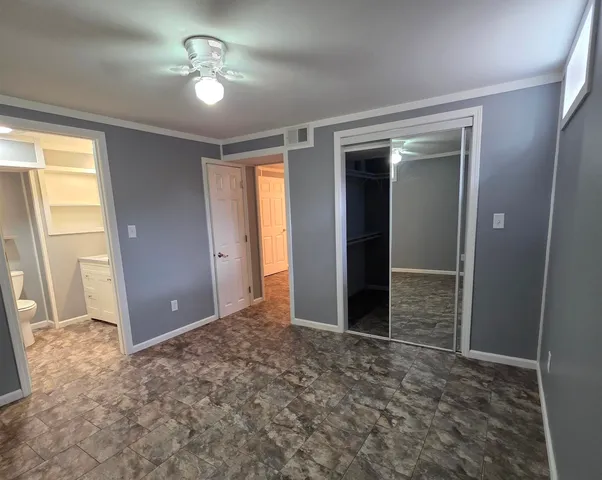 an empty room with a empty space and chandelier fan