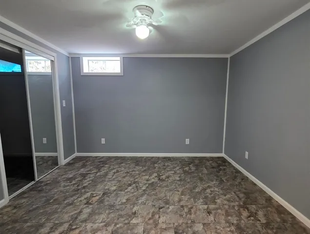a bathroom with a toilet sink vanity and mirror