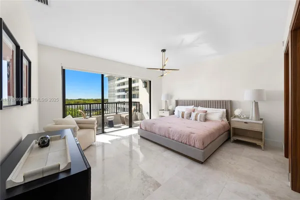 a spacious bedroom with a bed couch and a large window