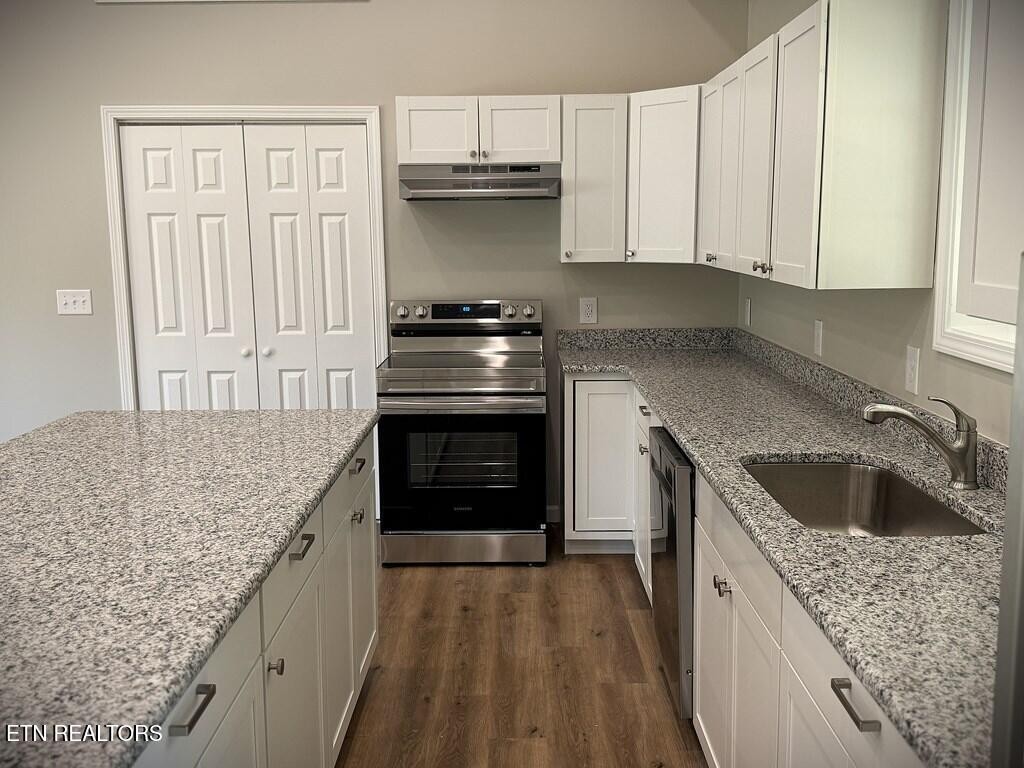 246 Ralph Spivey Lane Hilham, TN 38568 - Photo 15 of 53 a kitchen with granite countertop a sink stove and cabinets