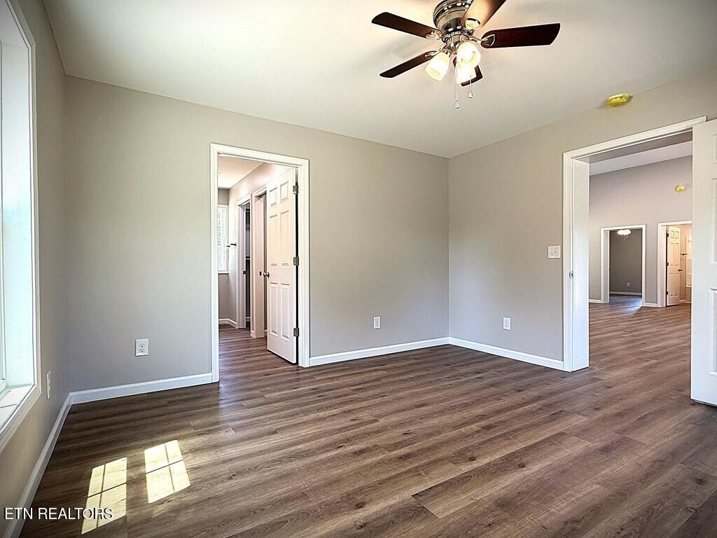 246 Ralph Spivey Lane Hilham, TN 38568 - Photo 22 of 53 a view of empty room with wooden floor and fan