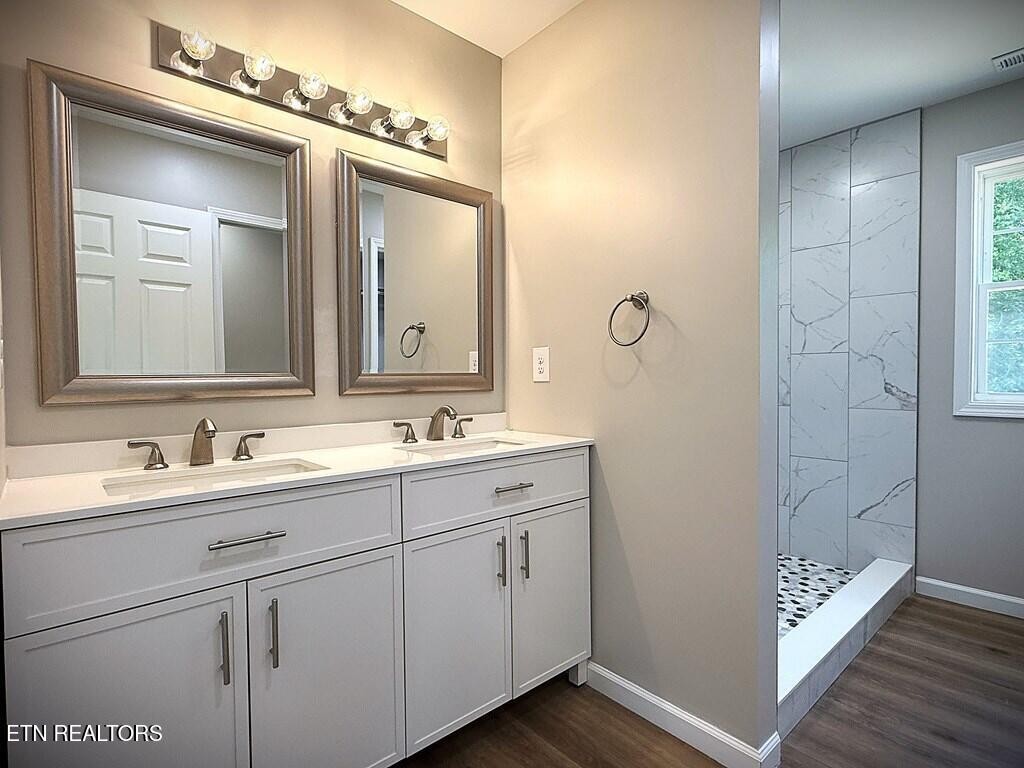 246 Ralph Spivey Lane Hilham, TN 38568 - Photo 23 of 53 a bathroom with a double vanity sink and mirror