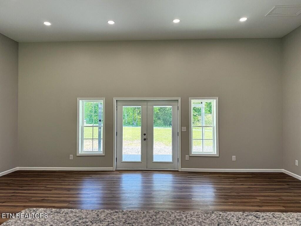 246 Ralph Spivey Lane Hilham, TN 38568 - Photo 30 of 53 an empty room with wooden floor and window