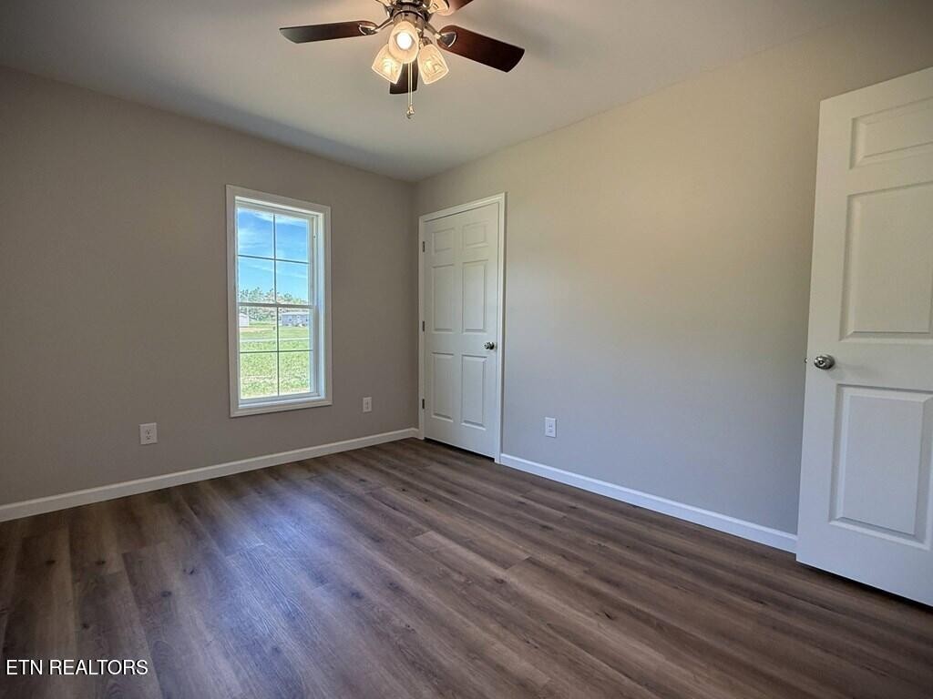 246 Ralph Spivey Lane Hilham, TN 38568 - Photo 31 of 53 an empty room with wooden floor and windows