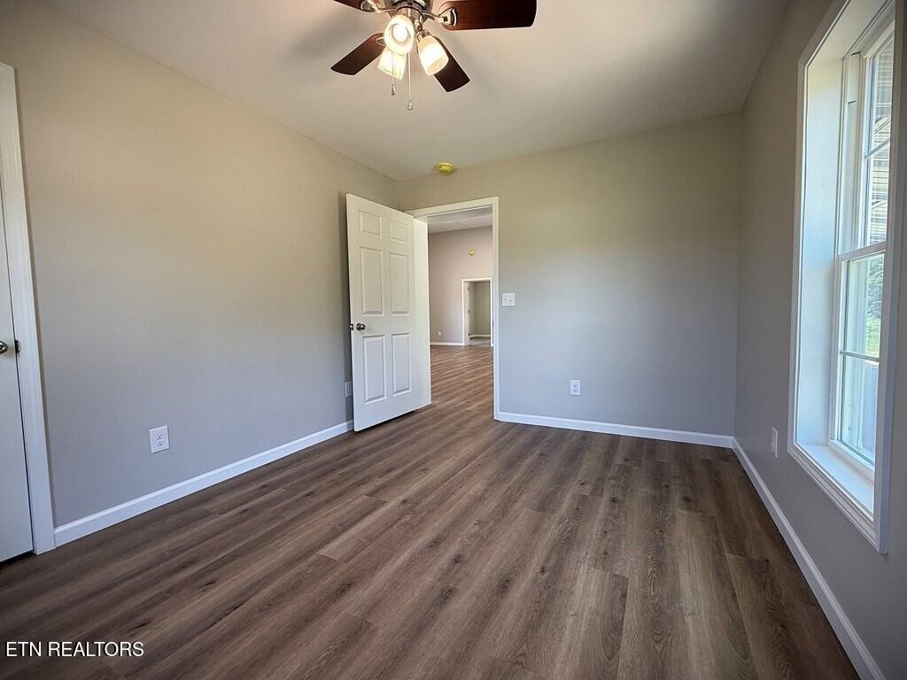 246 Ralph Spivey Lane Hilham, TN 38568 - Photo 32 of 53 wooden floor in an empty room with a window