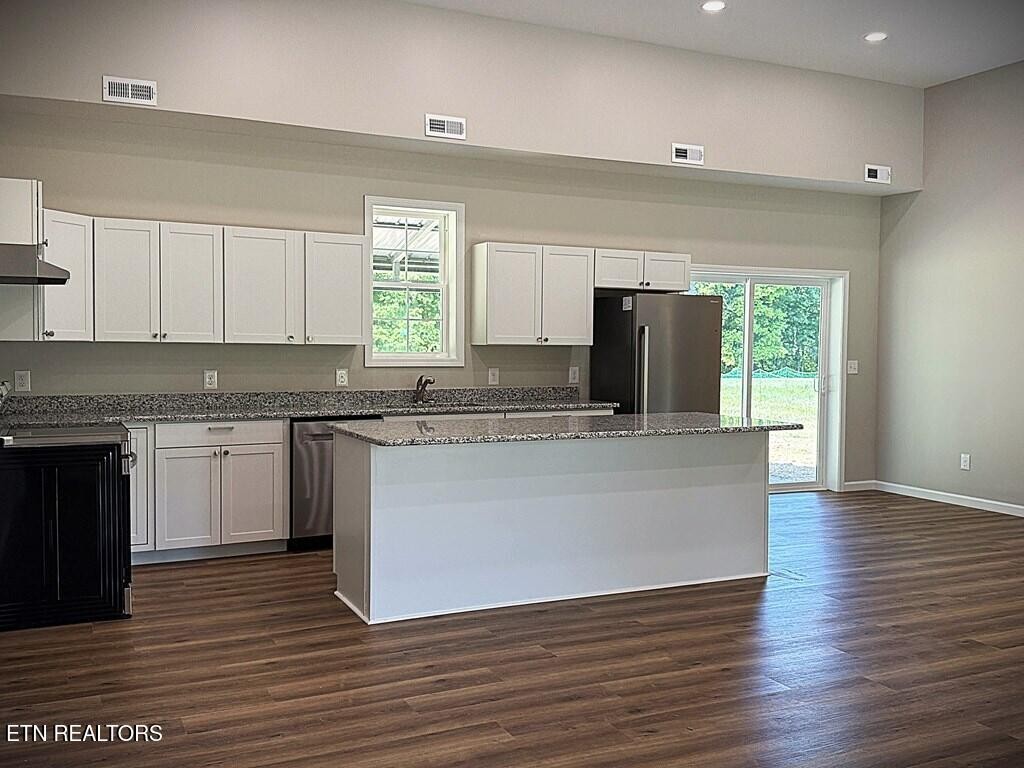 246 Ralph Spivey Lane Hilham, TN 38568 - Photo 10 of 53 a kitchen with granite countertop a stove a sink and a refrigerator