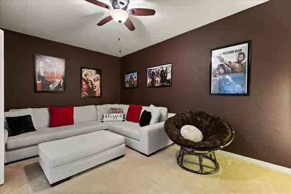 a living room with furniture and a chandelier