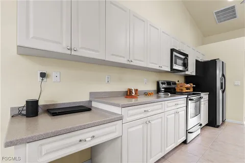 a kitchen with stainless steel appliances granite countertop a sink a stove and a refrigerator