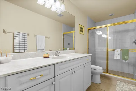 a bathroom with a double vanity sink toilet and shower
