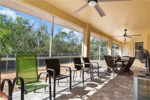 a view of a patio with dining table and chairs