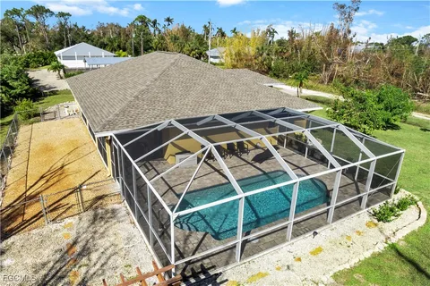 a view of backyard with swimming pool and outdoor seating