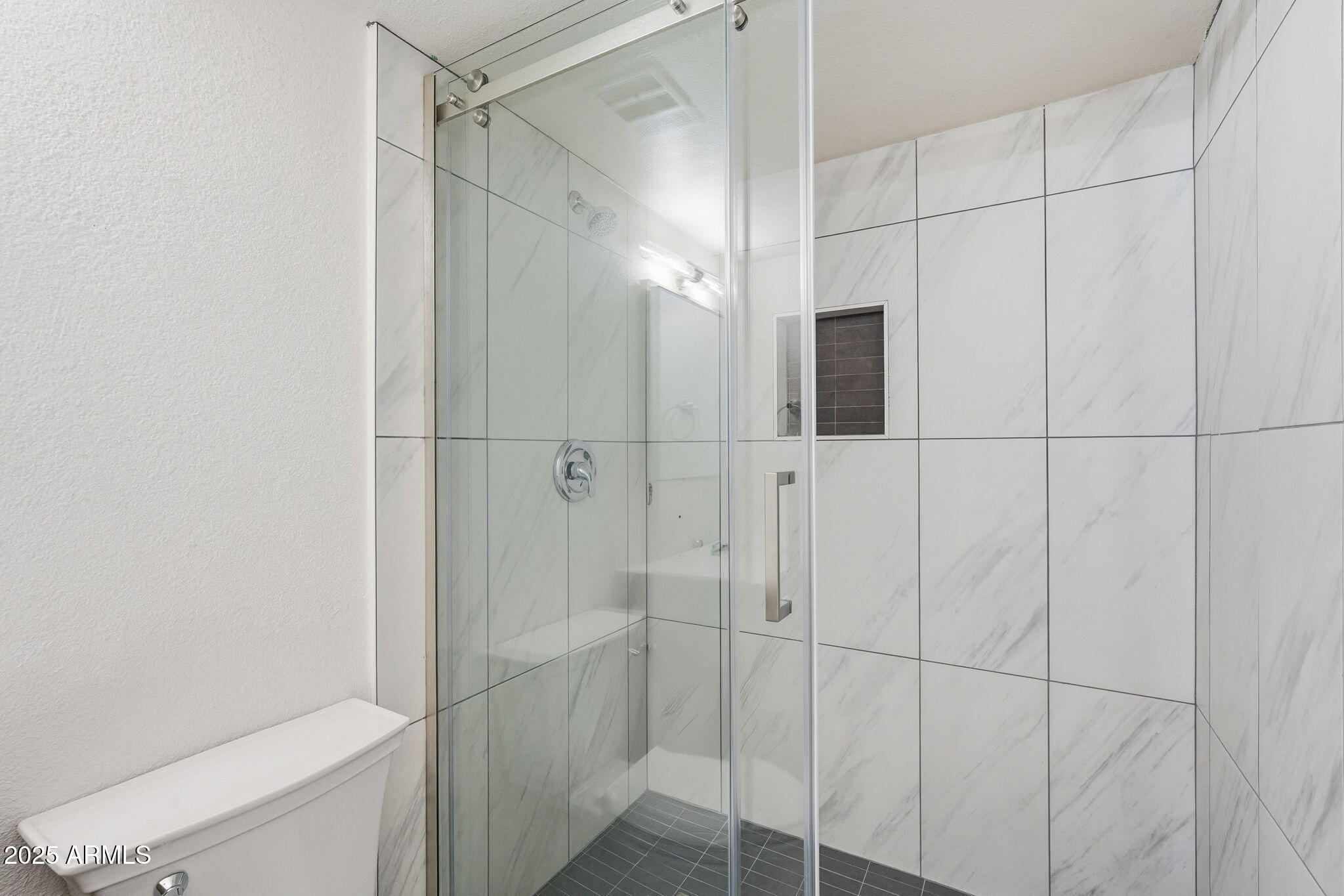 4201 East Camelback Road, Unit 74 Phoenix, AZ 85018 - Photo 13 of 20 a bathroom with a shower and a toilet